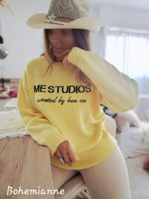 Une femme porte un pull tendance femme jaune à motifs tendance confortable pour la mi saison tissus très doux et des couleurs avec du pep's