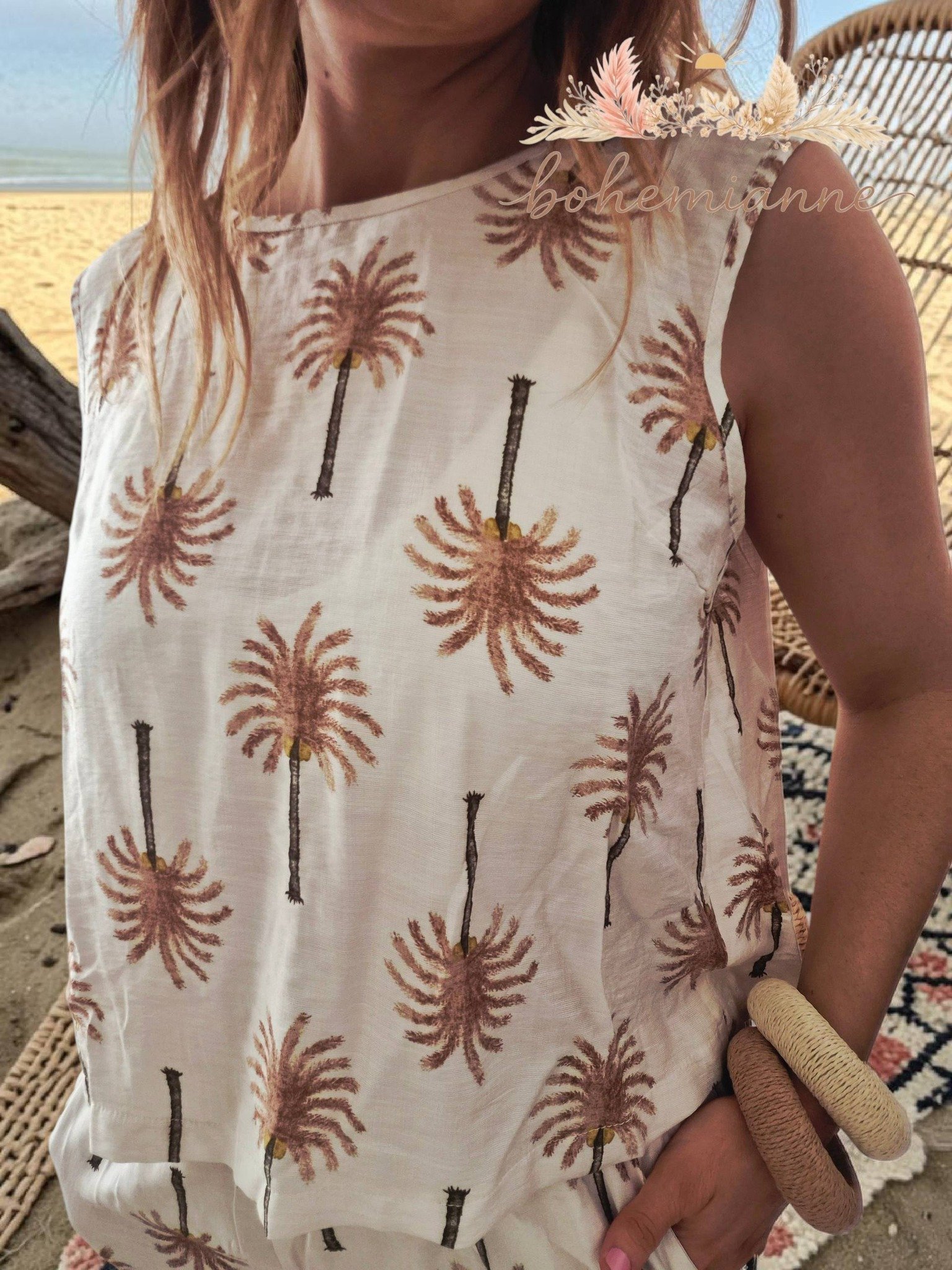 Ensemble bohème femme beige à imprimé palmiers, top fluide et pantalon large, style californien plage chic.